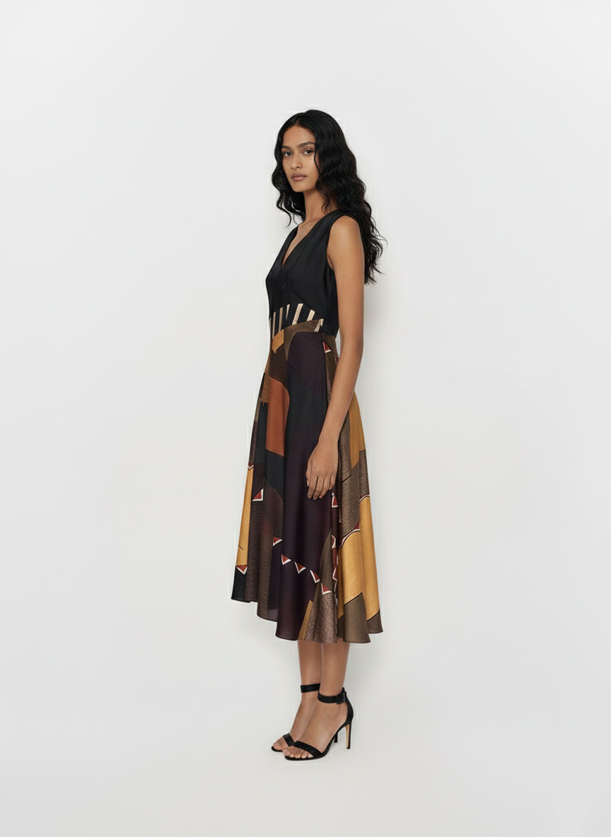 Sleeveless V-neck midi dress with a structured waist and abstract patchwork pattern in earthy tones