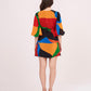 Back of the mini dress displaying the vibrant geometric print continuity and relaxed puff sleeve fit.