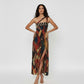Full-length one-shoulder dress featuring a high thigh slit and a diagonal double-strap neckline detail for a structured look.