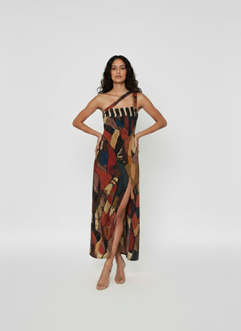 Full-length one-shoulder dress featuring a high thigh slit and a diagonal double-strap neckline detail for a structured look.