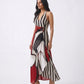 Bold monochrome striped maxi dress accented with a crimson red abstract panel