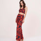 Side view of model wearing geometric print co-ord set with muslin sweetheart top and flared printed pants in a bold silhouette.