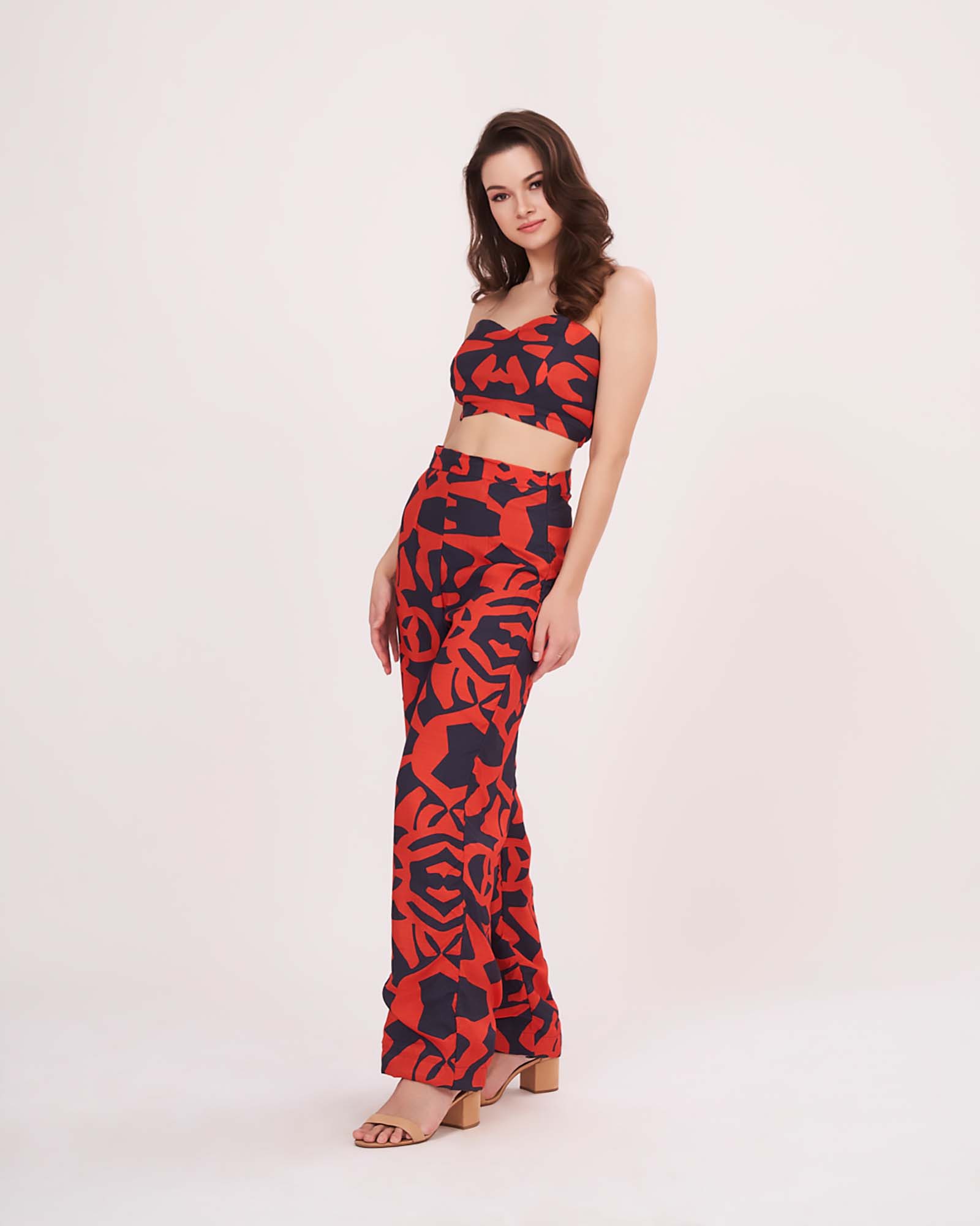 Side view of model wearing geometric print co-ord set with muslin sweetheart top and flared printed pants in a bold silhouette.