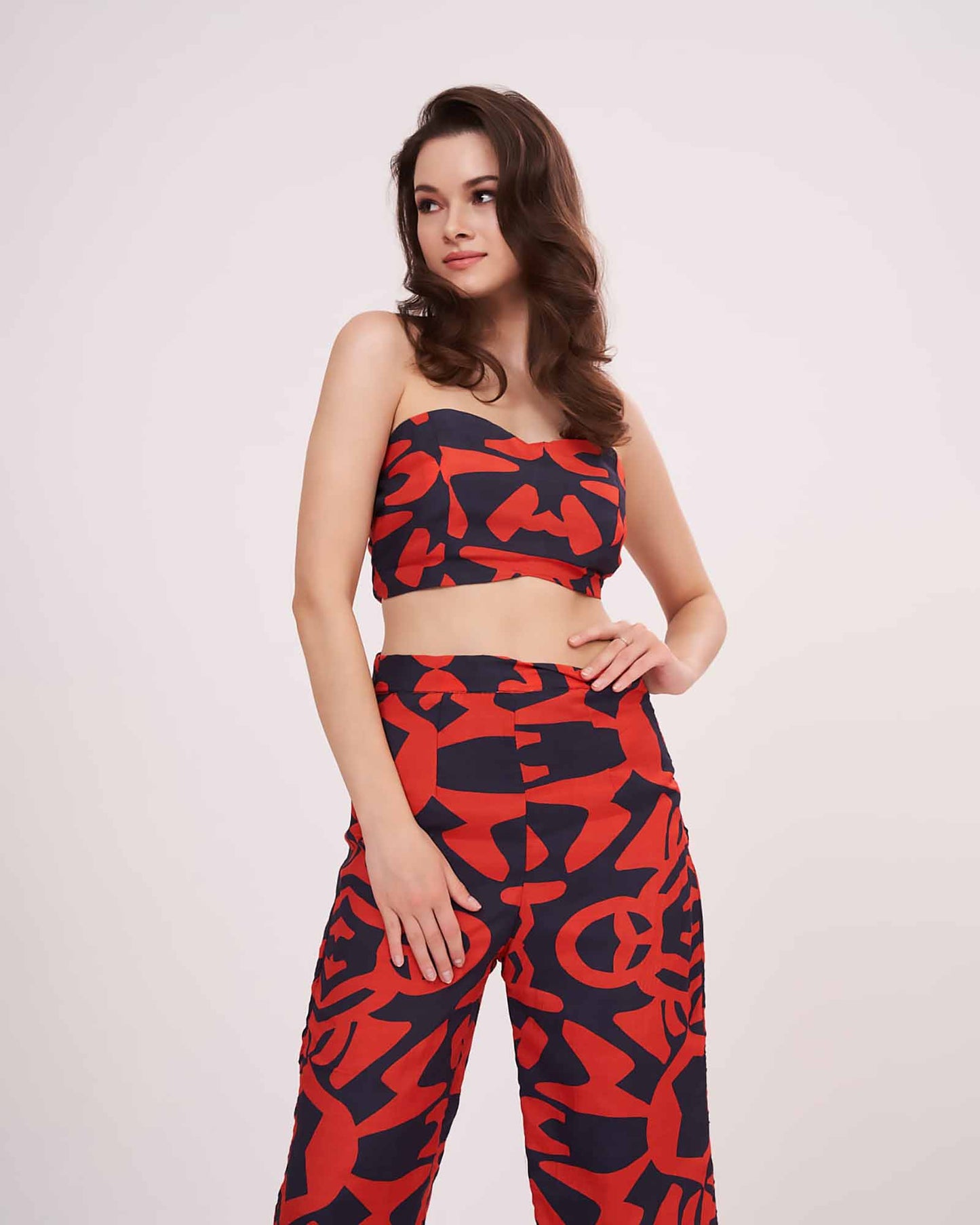 Model in multicolor printed co-ord set with sweetheart neck crop top and parallel pants, standing front-facing with arms relaxed.
