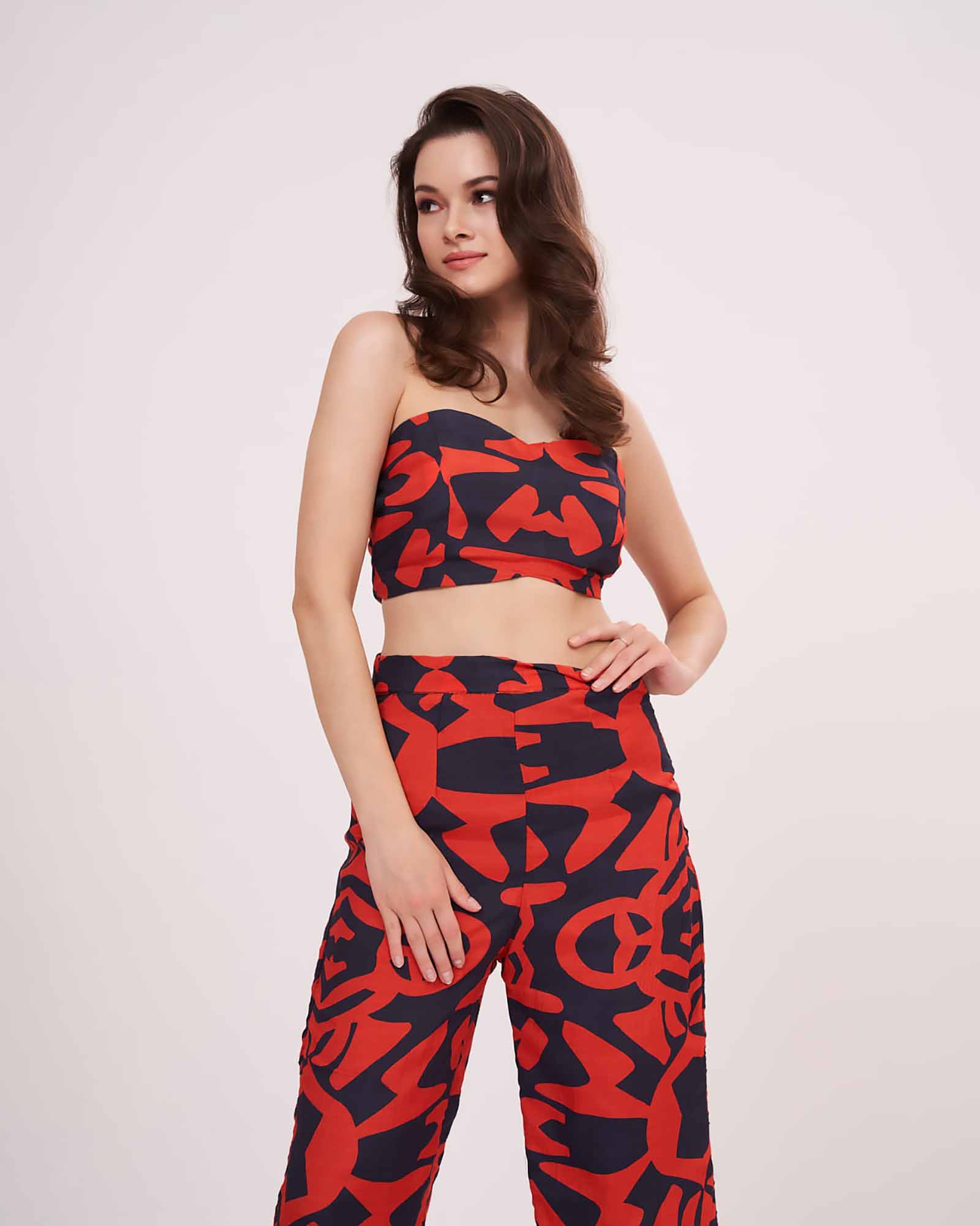 Model in multicolor printed co-ord set with sweetheart neck crop top and parallel pants, standing front-facing with arms relaxed.