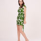Model in side pose h, showcasing wrap neckline and playful abstract green print.