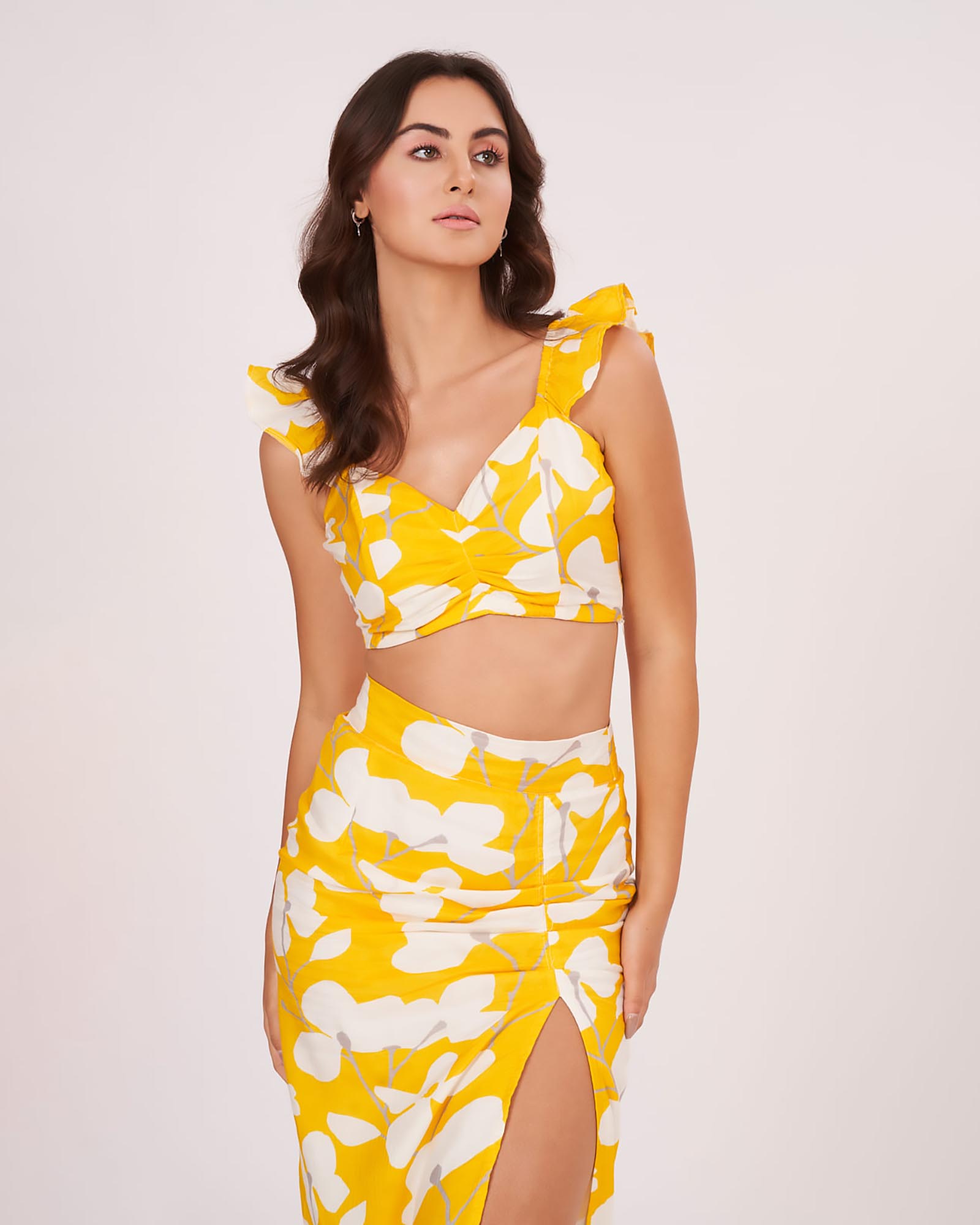 Yellow printed muslin co-ord set with sweetheart neckline, ruffle straps, and full view of abstract print skirt.