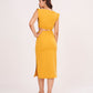 Rear view of the mustard yellow co-ord set showing the back zip closure and elasticated waist of the skirt, offering a seamless, comfortable finish.