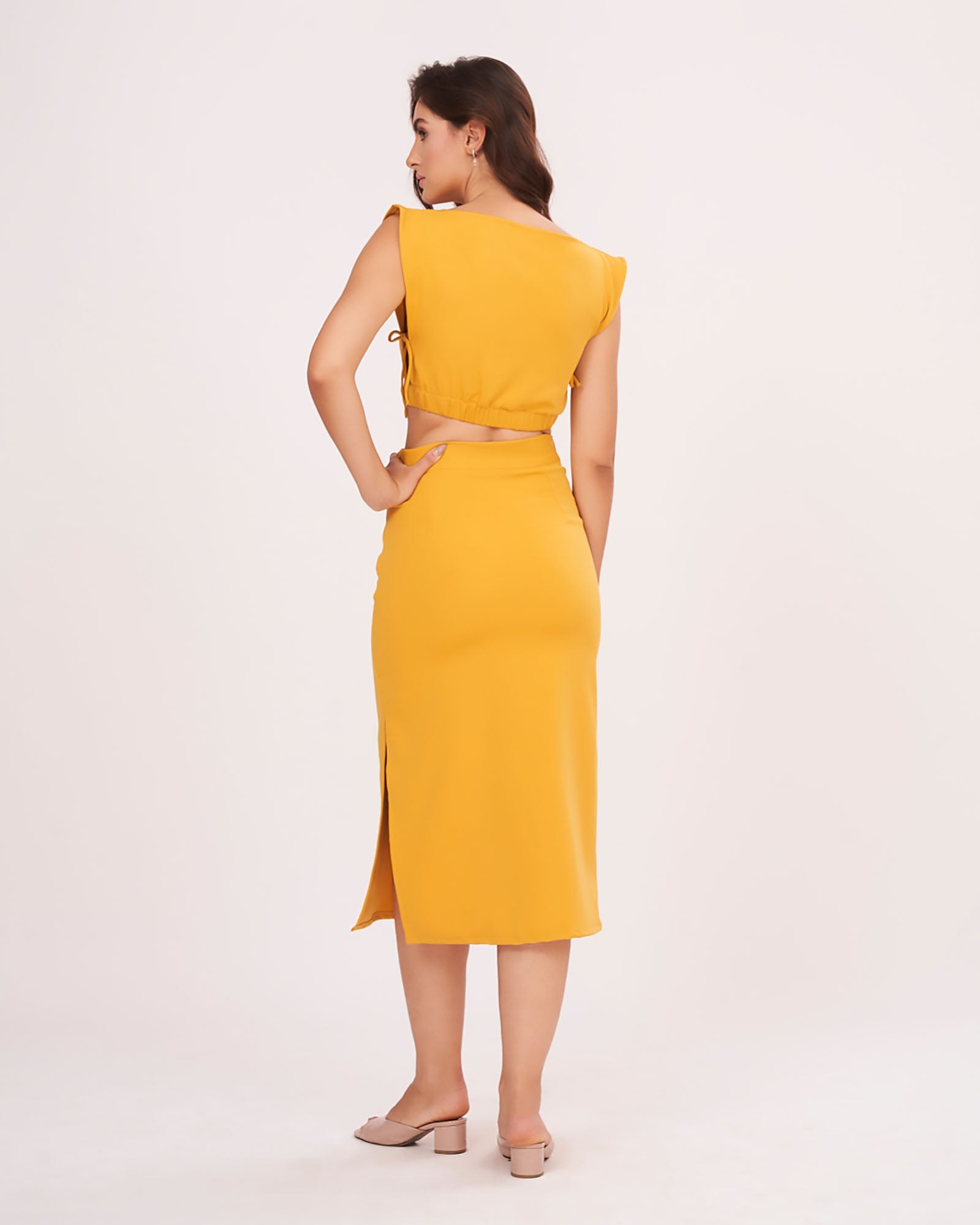 Rear view of the mustard yellow co-ord set showing the back zip closure and elasticated waist of the skirt, offering a seamless, comfortable finish.