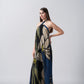 Model standing in studio setting in navy and beige floral halter dress, hands at sides for silhouette clarity.