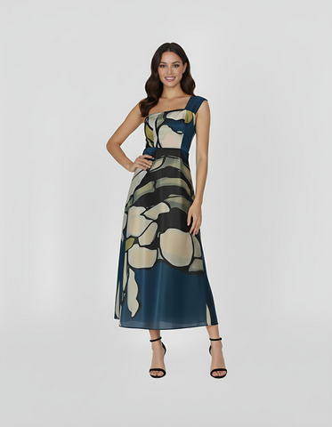 Full-length, one-shoulder dress featuring a striking oversized floral print in shades of midnight blue, sage green, and muted cream. The sleek, asymmetrical one-shoulder neckline creates a modern silhouette.
