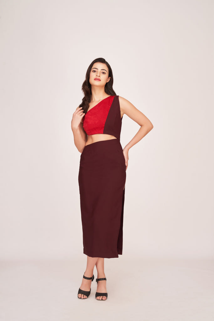 Model wearing a brown and red one-shoulder satin date night dress, standing front-facing with hands on waist.