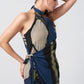 Close-up side angle of model wearing navy blue crepe dress with halter neck and asymmetric shoulder cut.