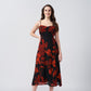 Orange and black abstract floral midi dress with a side slit, suitable for evening soirées and resort vacations