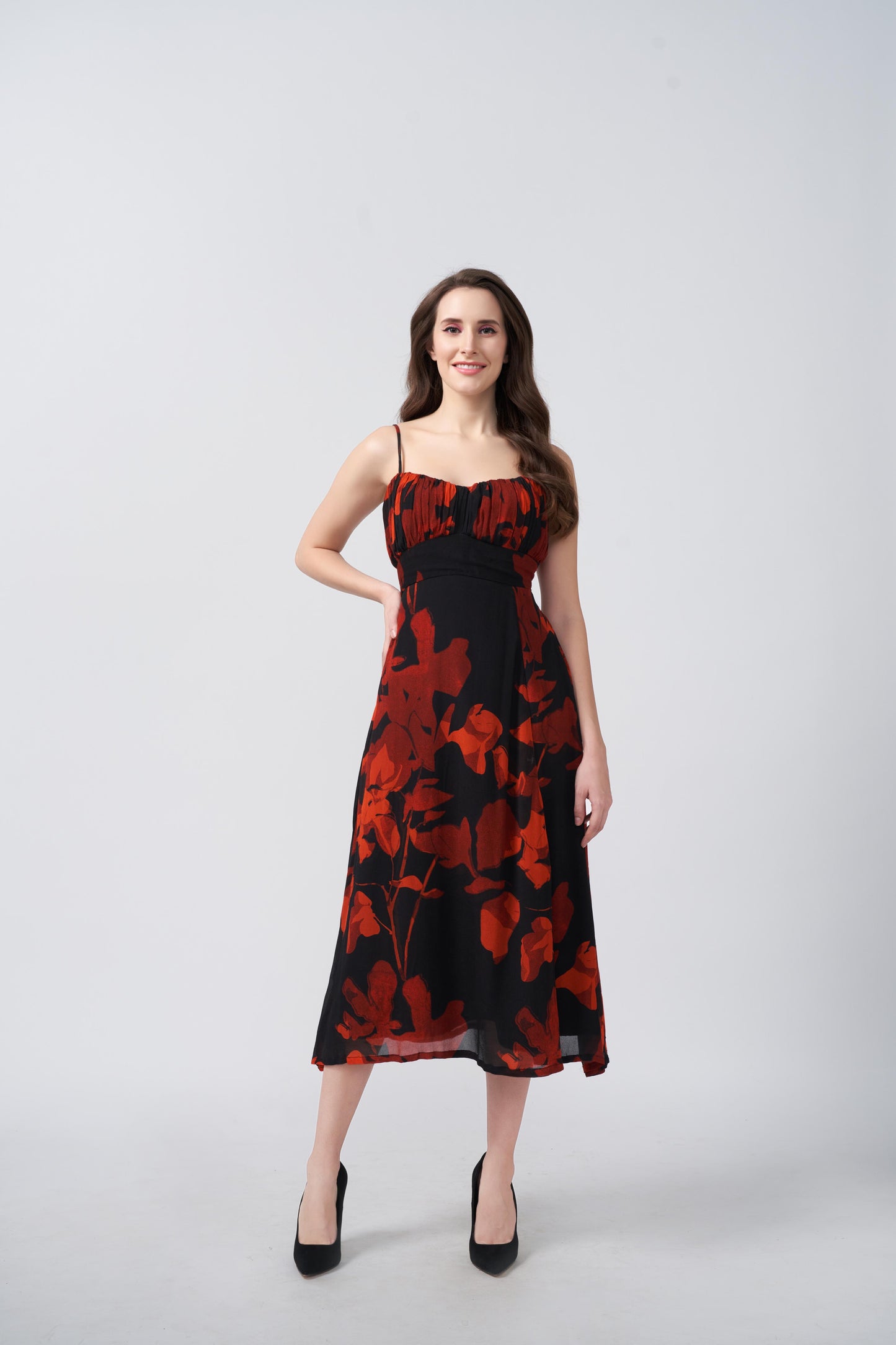 Orange and black abstract floral midi dress with a side slit, suitable for evening soirées and resort vacations