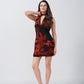 Model in orange and black abstract floral short dress with V-neck and tie-back, front-facing studio pose.