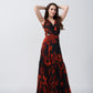 Model posing with hands raised, showcasing the flared silhouette and bold floral print.