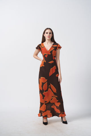 V-neck maxi dress featuring a warm palette of sunset orange and deep chocolate brown abstract botanical shapes.