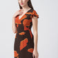 Side view of the crepe dress showing ruffle sleeve and profile of the long silhouette.