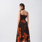 Rear view of the model in the abstract midi dress, revealing back details and dress flow.