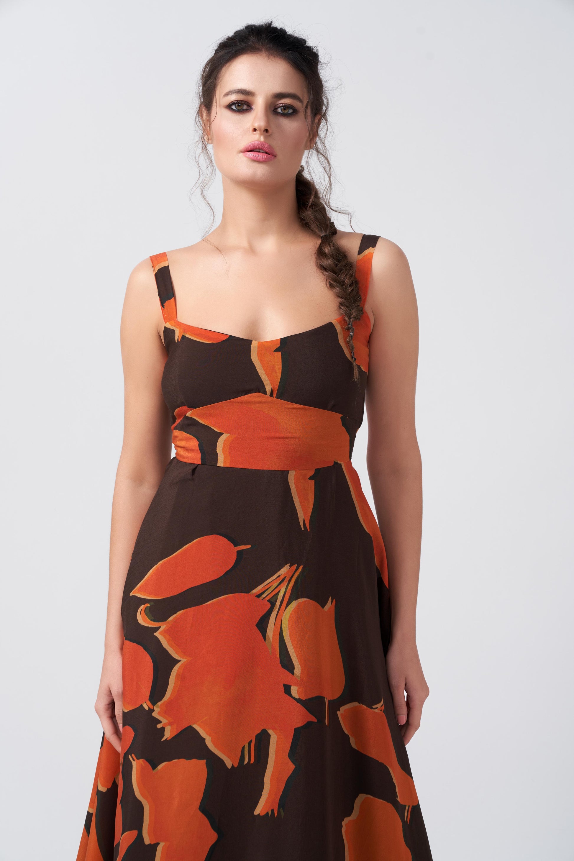 Studio close-up of the model in the abstract print dress, highlighting neckline and print details.
