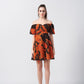 Model standing straight in vibrant puff sleeve mini dress with abstract pattern and flared hem.