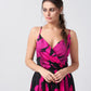 Close-up of model in overlap neck pink floral satin dress with delicate spaghetti straps.