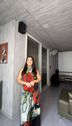 Halter-neck crepe maxi dress featuring a crossover detail and oversized floral abstract print, suitable for evening gatherings or cocktail events.