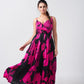 Model wearing an ankle-length satin dress with pink and black floral print, overlap neck, and spaghetti straps.