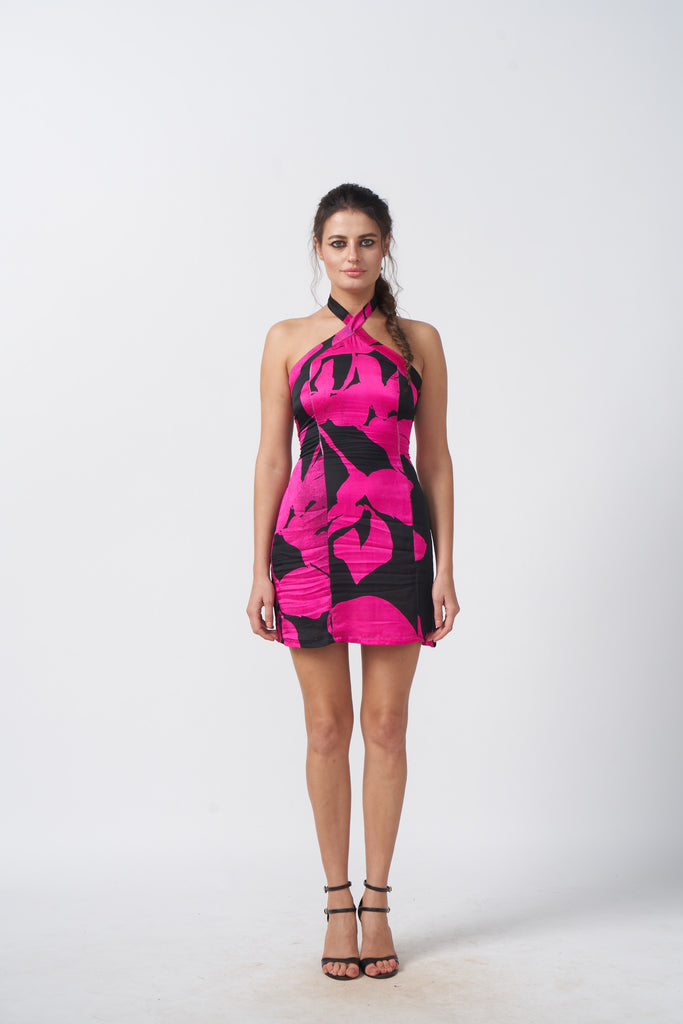 Model facing front in pink and black floral satin short dress with halter neck.