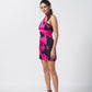 Full-length standing side pose showing the flow and short hemline of the halter tie-back dress.