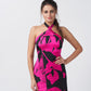 Model with hands on waist highlighting the neckline and structured fit of the dress.