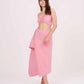 Model in a relaxed standing pose wearing the pink halter neck crop top and matching ruched skirt with side frill detail.