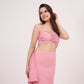Full frontal image of the pink co-ord set showing the halter neck detailing and playful hem of the skirt.