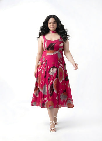 Pink floral chinon midi dress with a sweetheart neckline and tie-up straps, designed for a flattering resort-ready look