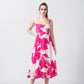 Model posing front-facing in a pink and white floral crepe midi dress with square neckline.