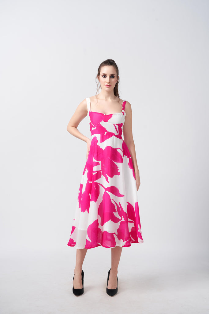 Model posing front-facing in a pink and white floral crepe midi dress with square neckline.