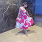 Model showing the soft drape and floral details of the crepe midi dress.