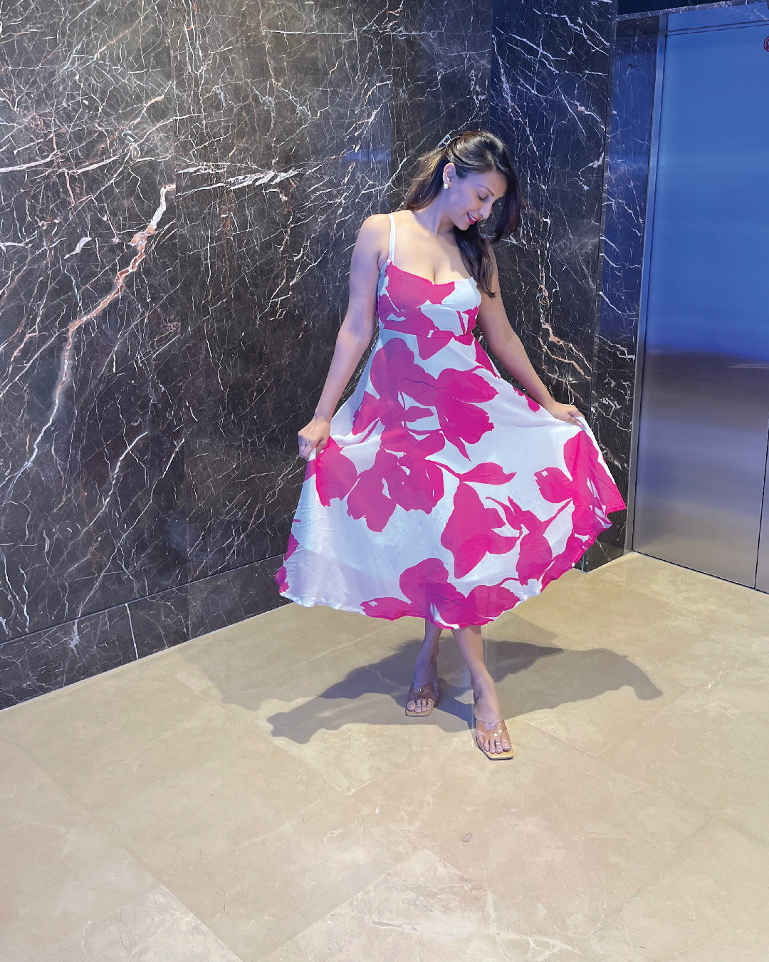Model showing the soft drape and floral details of the crepe midi dress.