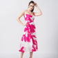 Model standing with one hand on her head, showing the flattering silhouette and movement of the dress.