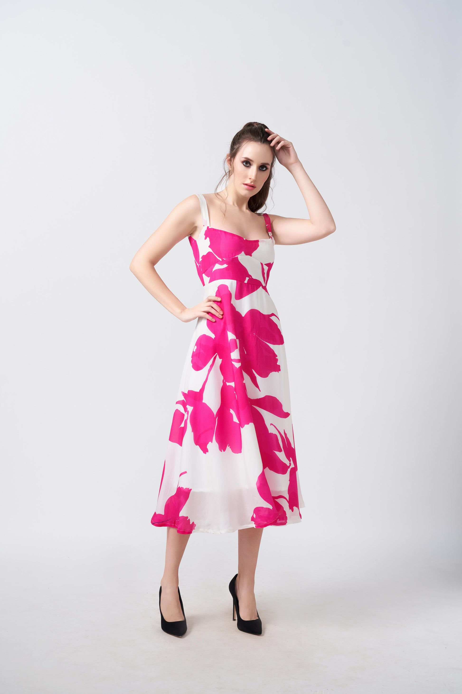 Model standing with one hand on her head, showing the flattering silhouette and movement of the dress.