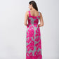 Back view of model in pink and grey floral satin maxi dress, highlighting wide straps and ankle length.