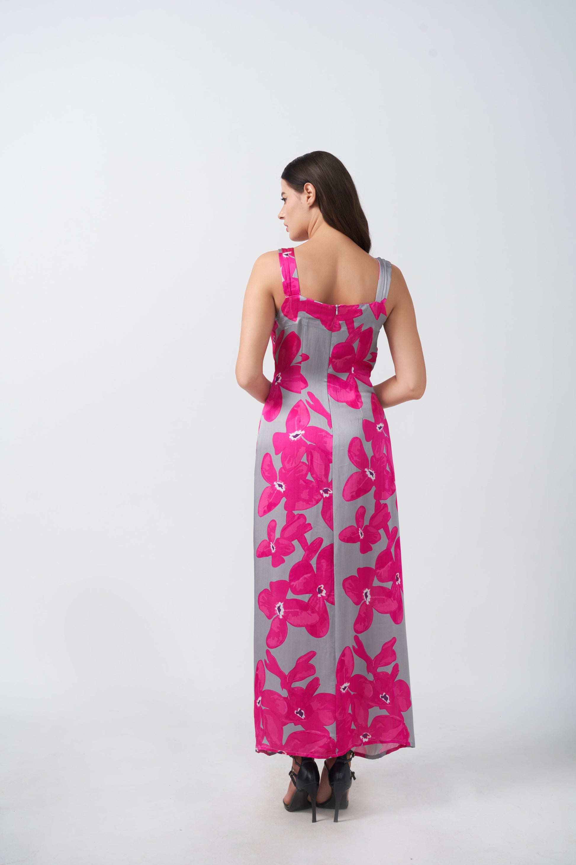 Back view of model in pink and grey floral satin maxi dress, highlighting wide straps and ankle length.