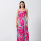 Model standing in a pink and grey floral satin maxi dress with spaghetti straps and square neckline.