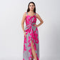 Front view of model in pink and grey floral satin maxi dress, featuring twisted waist and ankle-length hem.