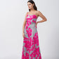 Model showing a side pose to highlight the flow and structure of the satin floral dress.