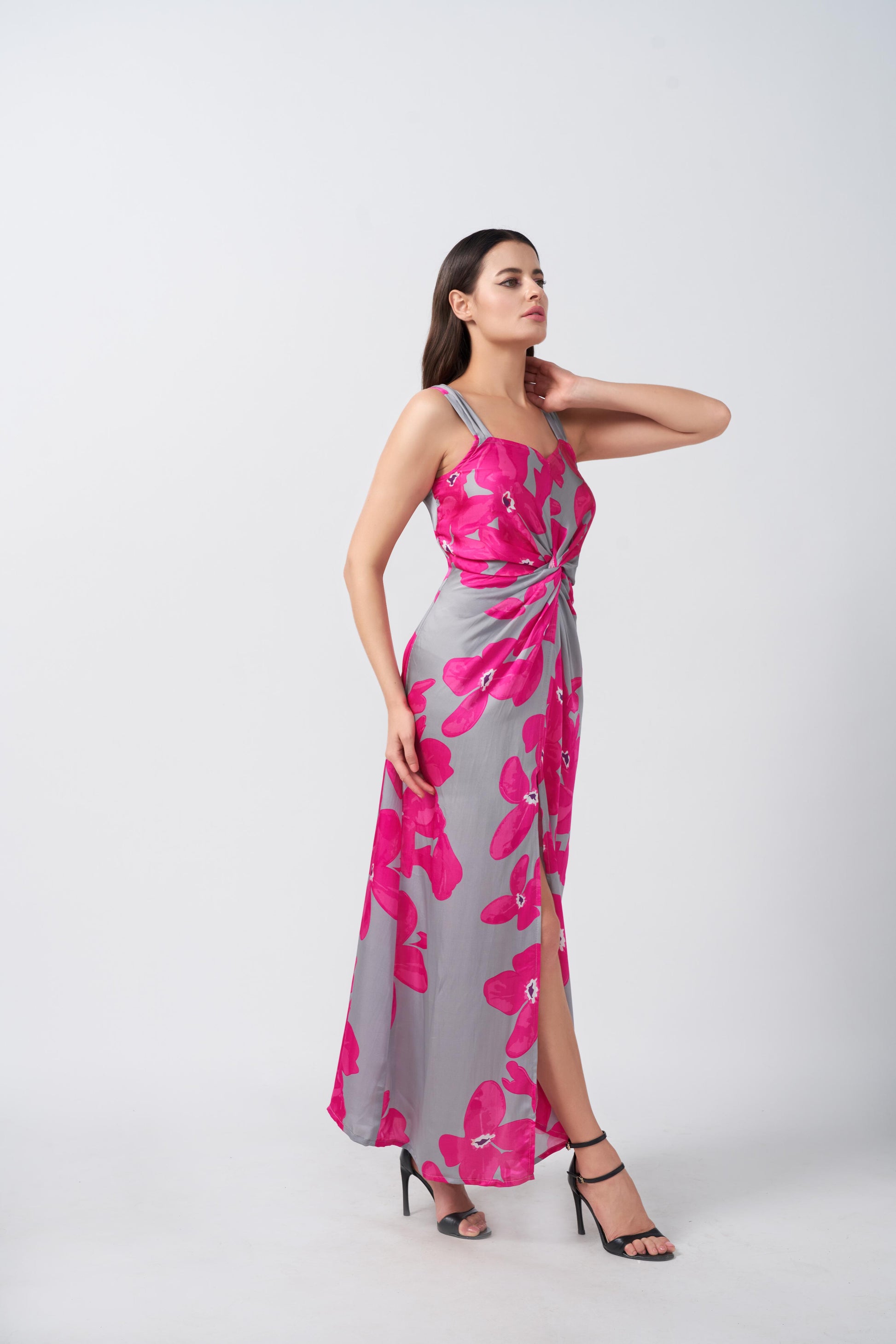 Model walking forward in satin pink and grey floral maxi dress, showcasing the fluid drape and movement.