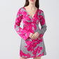 Front view of model in pink and grey floral short dress, showcasing the balanced silhouette and vibrant print.