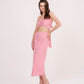 Side angle view of the pink crop top and skirt co-ord, emphasizing the ruched top and flowing frill of the skirt.