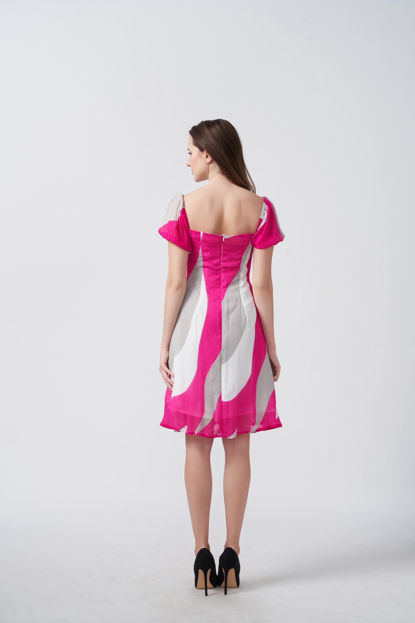 Back view of pink and white printed chinon dress showing short hemline and lightweight flow.